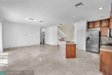 Discover this beautiful 2-story residence at the gated community on Palm-Aire Country Club and Resort - The Oaks in Florida - for sale on GolfHomes.com, golf home, golf lot