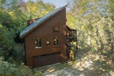 Nestled on a sprawling private lot, this enchanting on Sapphire National Golf Club in North Carolina - for sale on GolfHomes.com, golf home, golf lot