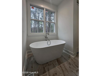 Discover refined living in this stunning new construction by on Seven Lakes Country Club in North Carolina - for sale on GolfHomes.com, golf home, golf lot