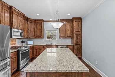 Tucked inside the Village of Highlands South, this 4-bedroom on Highland Oaks Golf Course in Alabama - for sale on GolfHomes.com, golf home, golf lot