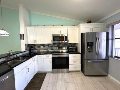 Beautifully renovated 2nd floor corner condo with expansive on Forest Oaks Golf Club in Florida - for sale on GolfHomes.com, golf home, golf lot