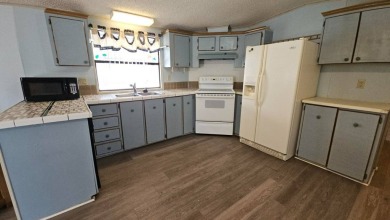 Cute 2 bedroom 2 bath home with newer flooring and is partially on Golden Lakes Golf Course in Florida - for sale on GolfHomes.com, golf home, golf lot