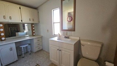 Cute 2 bedroom 2 bath home with newer flooring and is partially on Golden Lakes Golf Course in Florida - for sale on GolfHomes.com, golf home, golf lot