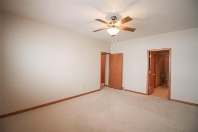 Open living room/dining room. Expensive carpet throughout. The on Hunters Ridge Golf Course in Iowa - for sale on GolfHomes.com, golf home, golf lot