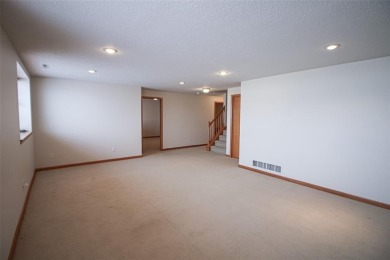 Open living room/dining room. Expensive carpet throughout. The on Hunters Ridge Golf Course in Iowa - for sale on GolfHomes.com, golf home, golf lot