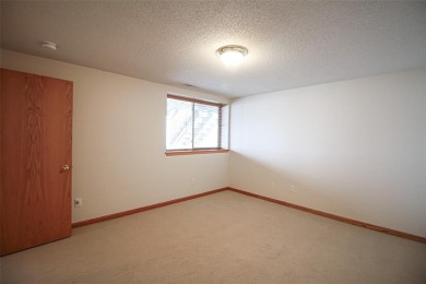 Open living room/dining room. Expensive carpet throughout. The on Hunters Ridge Golf Course in Iowa - for sale on GolfHomes.com, golf home, golf lot