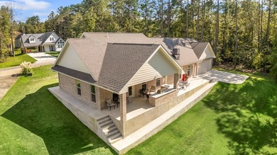 Serenity meets sophistication in this stunning waterfront on Rayburn Country Club in Texas - for sale on GolfHomes.com, golf home, golf lot