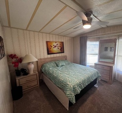 Discover easy Florida living in this 2-bedroom, 2-bath home on Lake Henry Golf Club in Florida - for sale on GolfHomes.com, golf home, golf lot