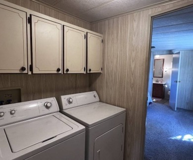 Discover easy Florida living in this 2-bedroom, 2-bath home on Lake Henry Golf Club in Florida - for sale on GolfHomes.com, golf home, golf lot