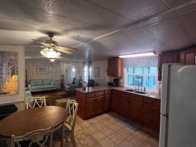 Discover easy Florida living in this 2-bedroom, 2-bath home on Lake Henry Golf Club in Florida - for sale on GolfHomes.com, golf home, golf lot