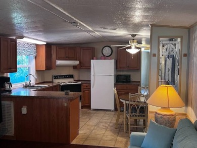 Discover easy Florida living in this 2-bedroom, 2-bath home on Lake Henry Golf Club in Florida - for sale on GolfHomes.com, golf home, golf lot