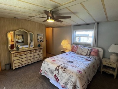 Discover easy Florida living in this 2-bedroom, 2-bath home on Lake Henry Golf Club in Florida - for sale on GolfHomes.com, golf home, golf lot