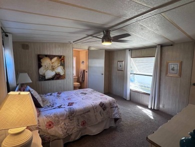 Discover easy Florida living in this 2-bedroom, 2-bath home on Lake Henry Golf Club in Florida - for sale on GolfHomes.com, golf home, golf lot