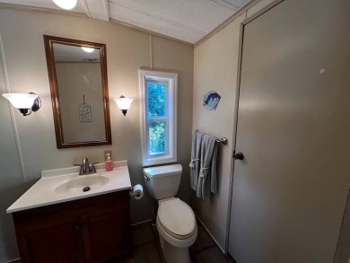 Discover easy Florida living in this 2-bedroom, 2-bath home on Lake Henry Golf Club in Florida - for sale on GolfHomes.com, golf home, golf lot