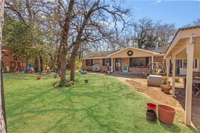 This 3 bed 2 bath brick home is tucked in the woods for ultimate on Hilltop Lakes Resort Golf Club in Texas - for sale on GolfHomes.com, golf home, golf lot