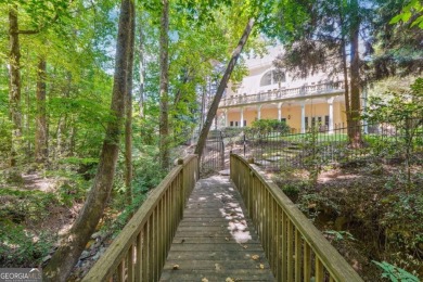 Experience three fully finished levels of exceptional living on The Golf Club of Georgia in Georgia - for sale on GolfHomes.com, golf home, golf lot