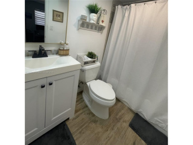Enjoy serene lake views and resort-style living in this on Sunrise Lakes Phase III in Florida - for sale on GolfHomes.com, golf home, golf lot