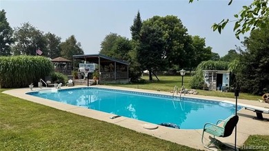 Enjoy a beautiful blend of comfort and character with this on Kearsley Lake Golf Course in Michigan - for sale on GolfHomes.com, golf home, golf lot