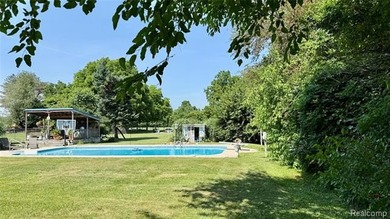 Enjoy a beautiful blend of comfort and character with this on Kearsley Lake Golf Course in Michigan - for sale on GolfHomes.com, golf home, golf lot