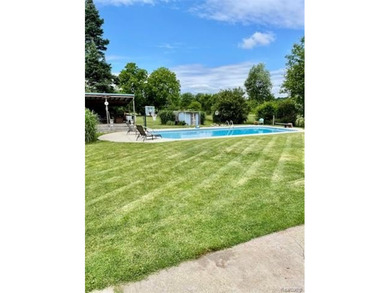 Enjoy a beautiful blend of comfort and character with this on Kearsley Lake Golf Course in Michigan - for sale on GolfHomes.com, golf home, golf lot