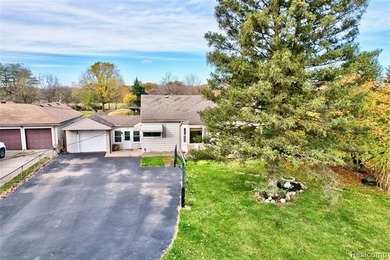 Enjoy a beautiful blend of comfort and character with this on Kearsley Lake Golf Course in Michigan - for sale on GolfHomes.com, golf home, golf lot