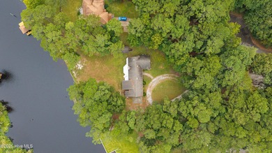 Welcome to your dream escape on the water! Nestled on wooded 2 on River Bend Golf and Country Club in North Carolina - for sale on GolfHomes.com, golf home, golf lot