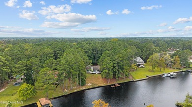 Welcome to your dream escape on the water! Nestled on wooded 2 on River Bend Golf and Country Club in North Carolina - for sale on GolfHomes.com, golf home, golf lot