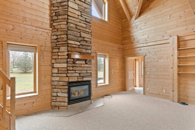 Beautiful custom log home on the 5th hole of the Mascoutin Golf on Mascoutin Country Club in Wisconsin - for sale on GolfHomes.com, golf home, golf lot