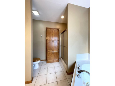 Meticulously maintained home with gorgeous lake views! Vinyl on Lake Perry Country Club in Kansas - for sale on GolfHomes.com, golf home, golf lot