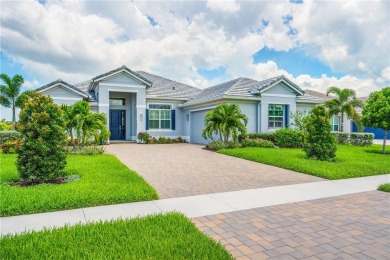 This newly built, elegant pool home backs to a serene lake on Bent Pine Golf Club in Florida - for sale on GolfHomes.com, golf home, golf lot