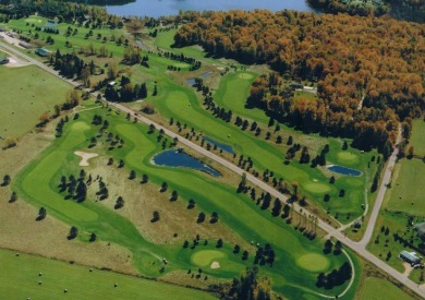 Prime location alert! Nestled on a one-acre lot bordering the on Maplewood Golf Course in Wisconsin - for sale on GolfHomes.com, golf home, golf lot