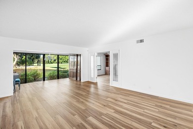 Serene golf course and pond views enhance this first-floor on Quail Ridge Golf Course and Country Club in Florida - for sale on GolfHomes.com, golf home, golf lot