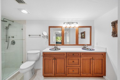 Serene golf course and pond views enhance this first-floor on Quail Ridge Golf Course and Country Club in Florida - for sale on GolfHomes.com, golf home, golf lot