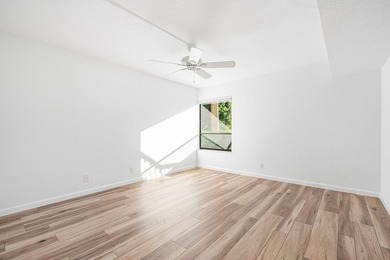 Serene golf course and pond views enhance this first-floor on Quail Ridge Golf Course and Country Club in Florida - for sale on GolfHomes.com, golf home, golf lot