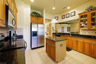 Experience refined coach home living in this beautifully on West Bay Beach and Golf Club in Florida - for sale on GolfHomes.com, golf home, golf lot