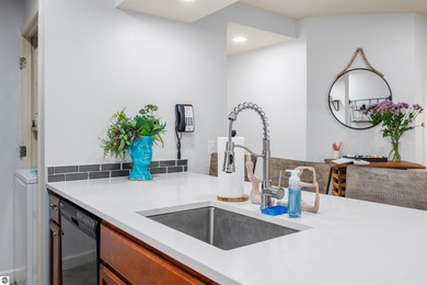 Perched above the third tee of Spruce Run Golf Course, this on Grand Traverse Resort and Spa in Michigan - for sale on GolfHomes.com, golf home, golf lot