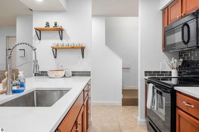 Perched above the third tee of Spruce Run Golf Course, this on Grand Traverse Resort and Spa in Michigan - for sale on GolfHomes.com, golf home, golf lot