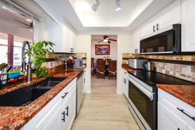 COMPLETELY REMODELED AND UPDATED 3/2/2 SAILBOAT WATER POOL HOME on Saint Andrews South Golf Club in Florida - for sale on GolfHomes.com, golf home, golf lot