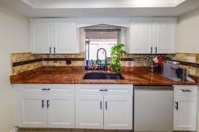 COMPLETELY REMODELED AND UPDATED 3/2/2 SAILBOAT WATER POOL HOME on Saint Andrews South Golf Club in Florida - for sale on GolfHomes.com, golf home, golf lot