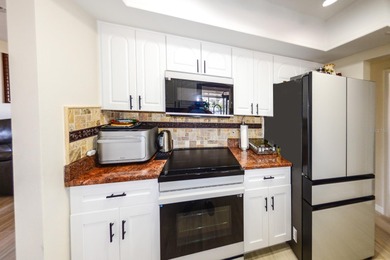 COMPLETELY REMODELED AND UPDATED 3/2/2 SAILBOAT WATER POOL HOME on Saint Andrews South Golf Club in Florida - for sale on GolfHomes.com, golf home, golf lot