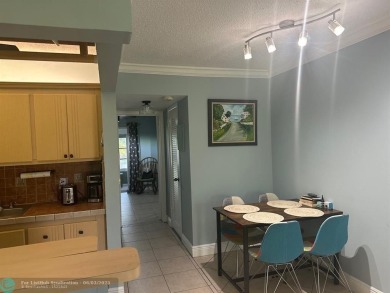 This condo has it all- tile throughout- new appliances - newer on Hillsboro Pines Golf in Florida - for sale on GolfHomes.com, golf home, golf lot