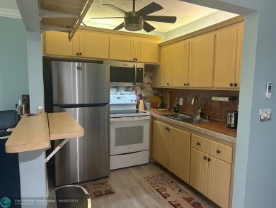 This condo has it all- tile throughout- new appliances - newer on Hillsboro Pines Golf in Florida - for sale on GolfHomes.com, golf home, golf lot