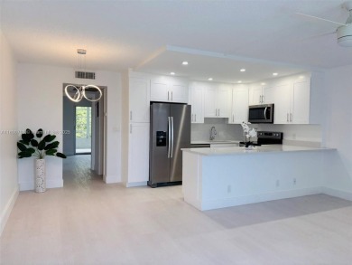 Contemporary designpletely renovated turnkey beautiful 1 bed 1.5 on Hillsboro Pines Golf in Florida - for sale on GolfHomes.com, golf home, golf lot