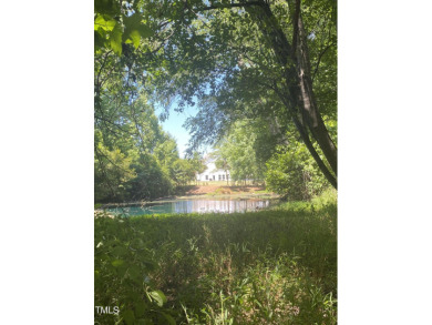 Welcome to your serene retreat nestled in a tranquil country on Reedy Creek Golf Course in North Carolina - for sale on GolfHomes.com, golf home, golf lot