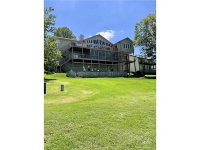 Need an incentive to move? This Holiday Island home is perched on Holiday Island Executive Golf Course in Arkansas - for sale on GolfHomes.com, golf home, golf lot