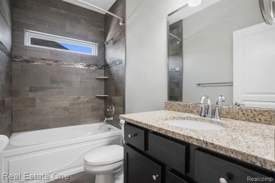 Custom built ranch with finished basement & a covered 288 sf on The Orchards Golf Club in Michigan - for sale on GolfHomes.com, golf home, golf lot