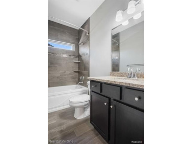 Custom built ranch with finished basement & a covered 288 sf on The Orchards Golf Club in Michigan - for sale on GolfHomes.com, golf home, golf lot