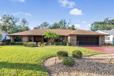 This beautiful brick home, nestled in the prestigious gated on Spruce Creek Golf Club in Florida - for sale on GolfHomes.com, golf home, golf lot