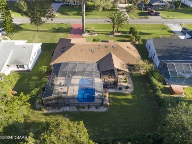 This beautiful brick home, nestled in the prestigious gated on Spruce Creek Golf Club in Florida - for sale on GolfHomes.com, golf home, golf lot