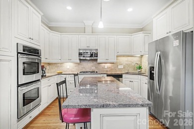 Handsome townhome tucked behind the 15th green of Raintree's on Raintree Country Club in North Carolina - for sale on GolfHomes.com, golf home, golf lot